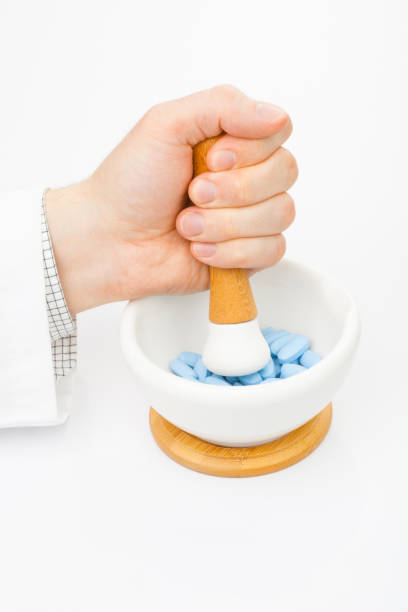 Grinding some blue pills with help of mortar and pestle