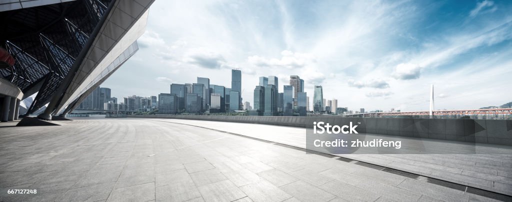 empty floor with modern cityscape and skyline empty brick floor with cityscape of modern city City Street Stock Photo