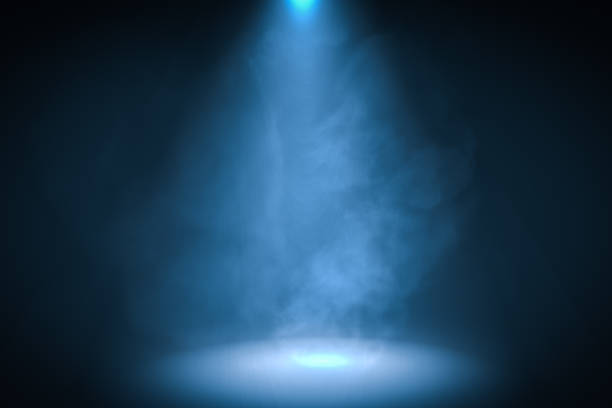 3D rendered illustration of blue spotlight background with smoke. 3D rendered illustration of blue spotlight background with smoke. stage performance space illustrations stock illustrations