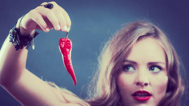 istock Woman wearing lingerie holding chilli pepper 667127816