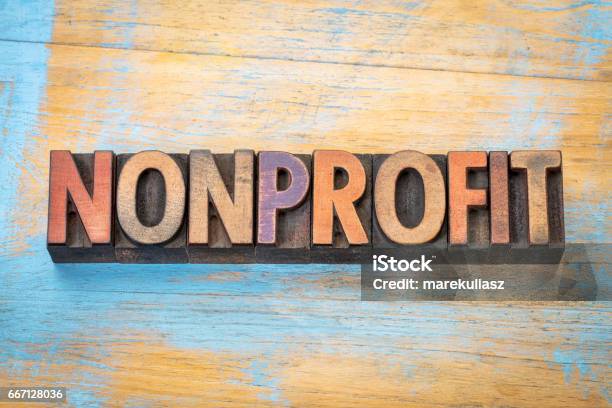 Nonprofit Word In Wood Type Stock Photo - Download Image Now - Non-Profit Organization, Business, Wood - Material