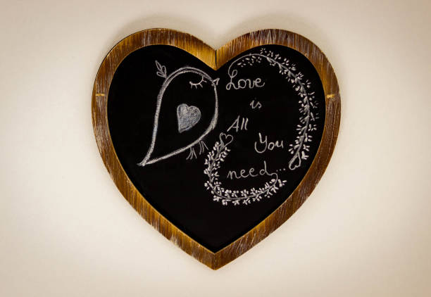 istock Heart Drawing On Chalk Board - Love is all you need 667134378