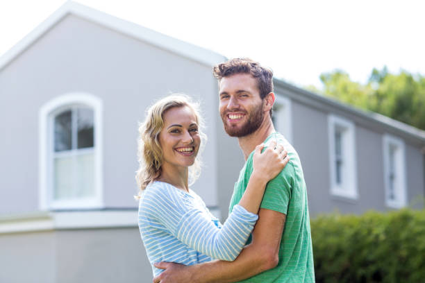 istock Couple embracing against house 667135826