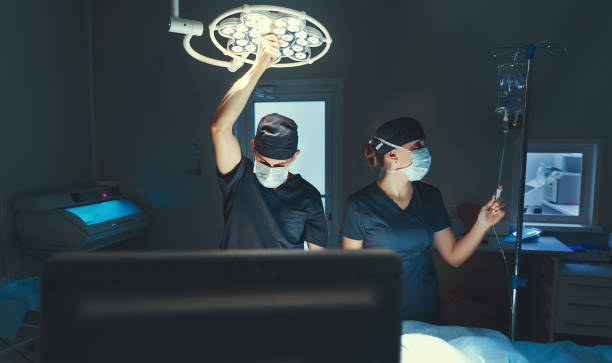 istock Doctor and assistant preparing for surgery in operating room 667138210