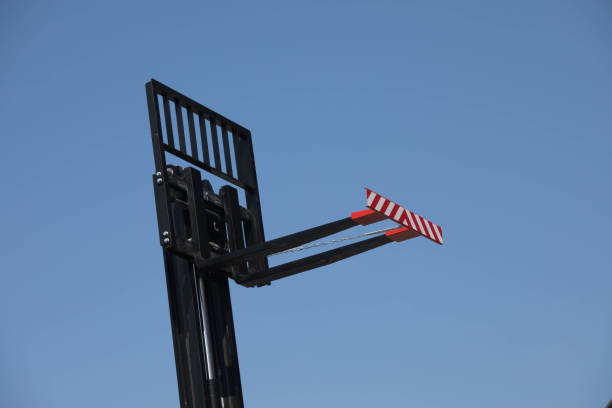 istock Empty Fork of a Forklift truck in front of blue sky 667138372