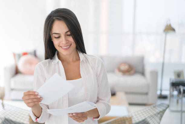 istock Woman at home getting the mail 667138484