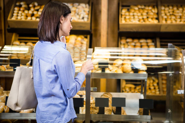 istock Beautiful woman choosing her bread 667143660