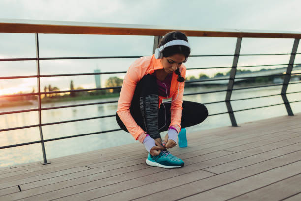 istock Woman running on riverside 667144702