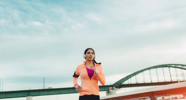 istock Woman running on riverside 667144706