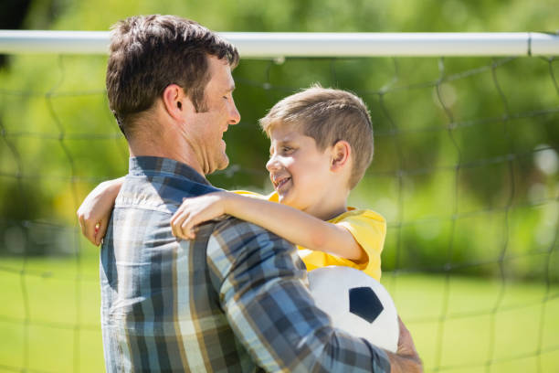 istock Father hugging son in the park 667144738