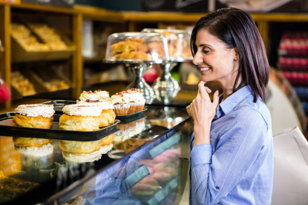 istock Pretty smiling woman choosing her dessert 667145192