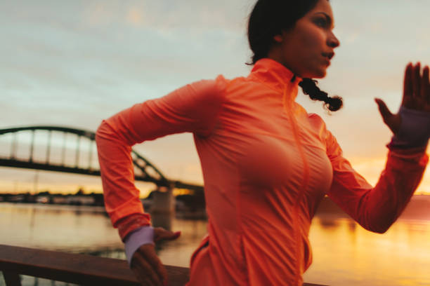 istock Woman running on riverside 667147304