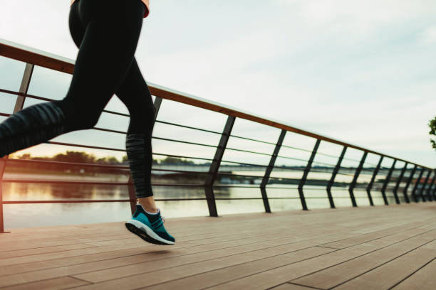 istock Woman running on riverside 667148188