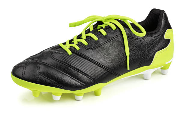 black leather football shoe or soccer boot isolated on white Single black leather football shoe or soccer boot isolated on white background with clipping path football boot stock pictures, royalty-free photos & images