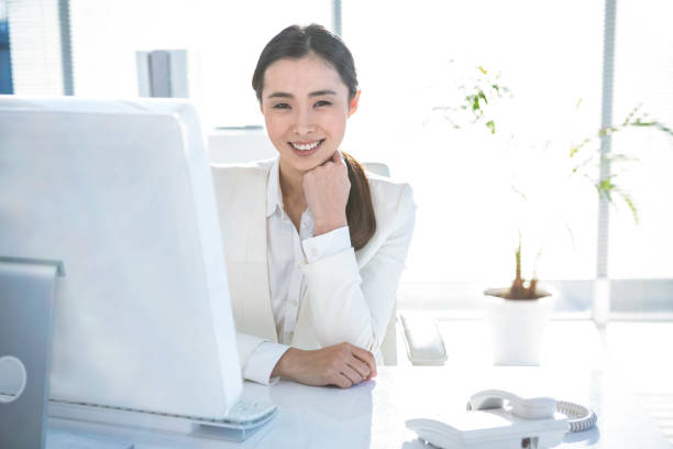 istock Smiling businesswoman working at her desk 667159648