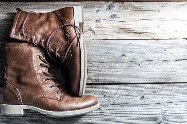 Photo of Close up view of brown leather man or woman new dry clean shoes, showing laces in detail.
