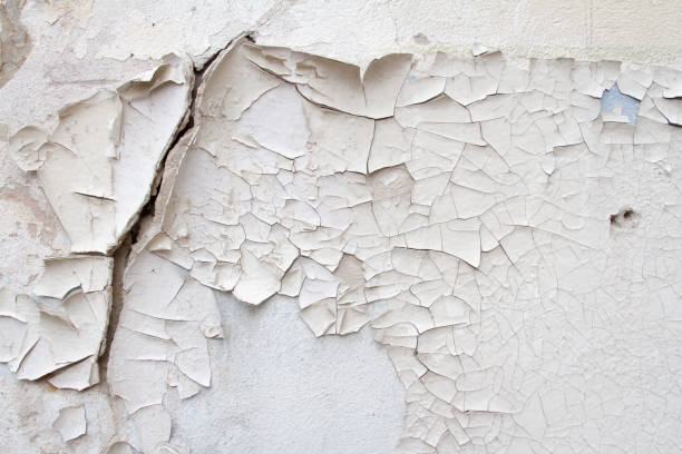 istock Vintage background texture of old brick masonry on ancient cement with cracks with traces of old paint. 667180338