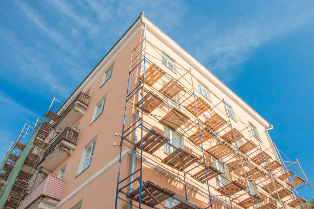 istock Scaffolding near the building bright sunny day blue sky 667181074