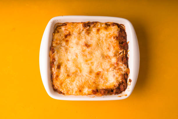 istock Homemade Meat lasagna on wooden yellow table copy space 667183770