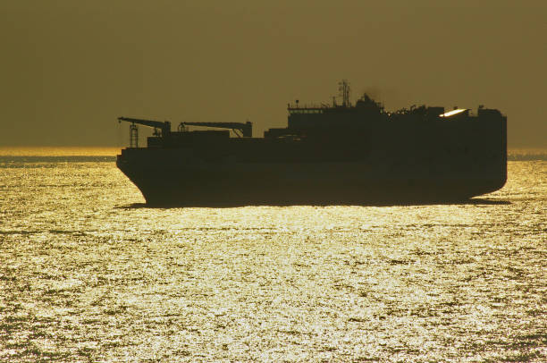 istock Backlit freighter in the North Sea at sunset 667184376