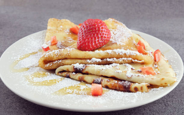 istock Two pancakes with strawberries on a plate. 667188722