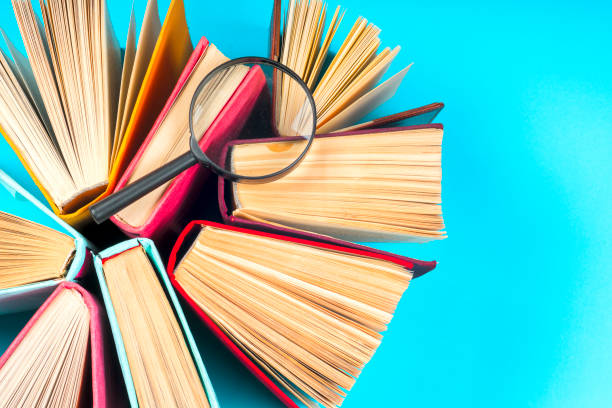 istock Top view of bright colorful hardback books in a circle. 667192082