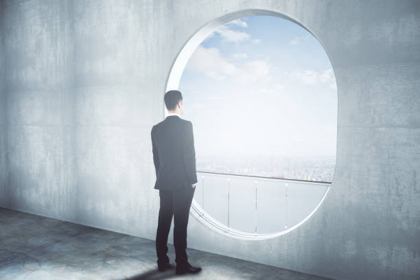 istock Thoughtful businessman in concrete interior side 667196958
