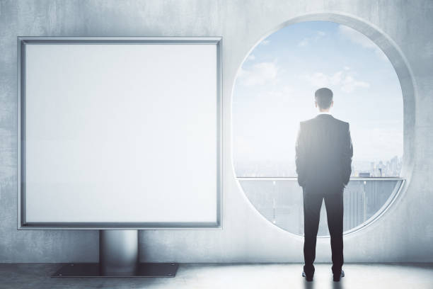 istock Man in room with square banner 667199890