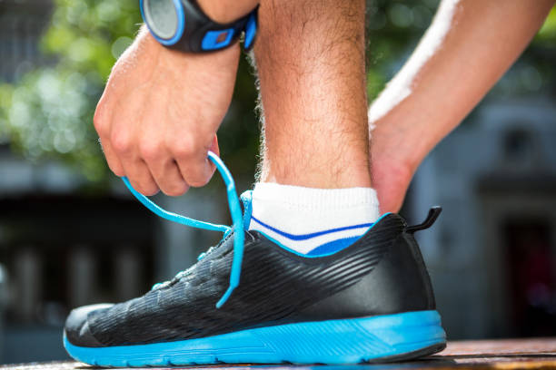 istock Athlete tying his shoes on a sunny day 667200104