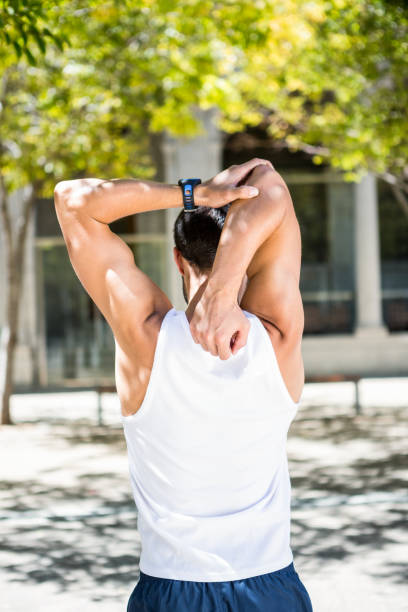 istock Rear view of athlete stretching his arm 667200230