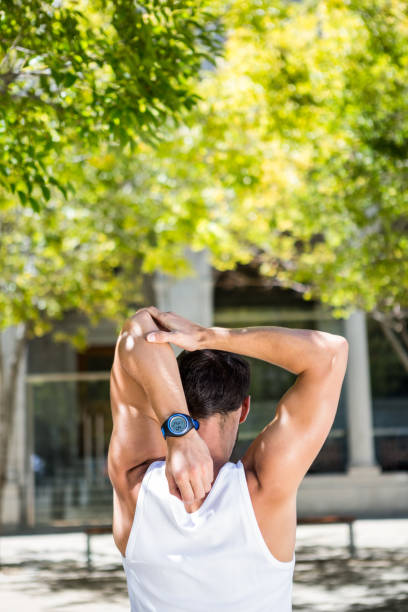 istock Rear view of athlete stretching his arm 667200292