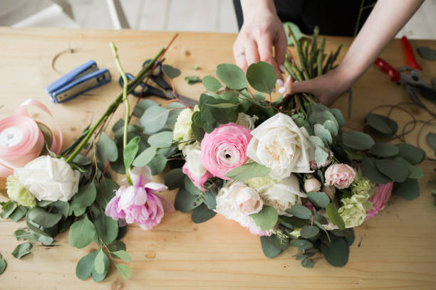 仕事で花屋: かなり若い女性ファッショ��ン異なるモダンな花束を作る - flower arrangement ストックフォトと画像