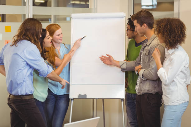 istock Business people looking at whiteboard 667202366