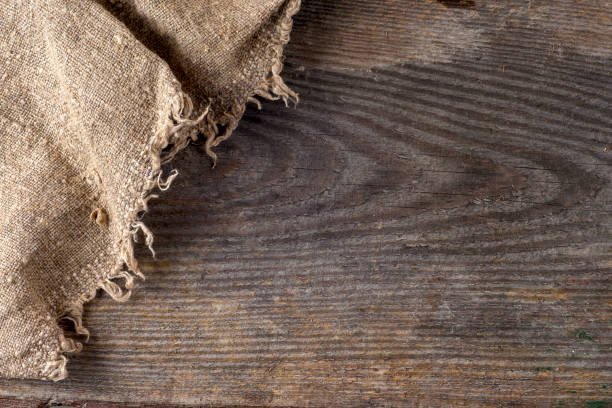 istock burlap hessian sacking on wooden background 667202368