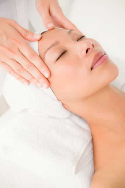 istock Attractive young woman receiving forehead massage 667202584