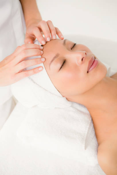 istock Attractive young woman receiving forehead massage 667202786