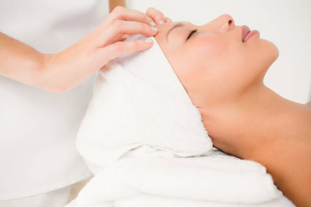 istock Attractive young woman receiving forehead massage 667202816