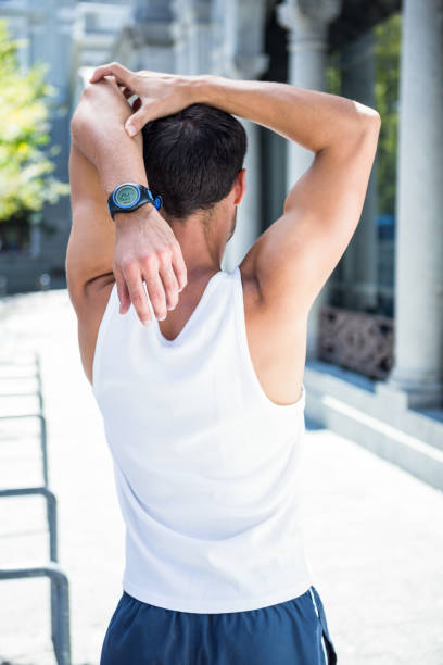 istock Rear view of athlete stretching his arm 667203356