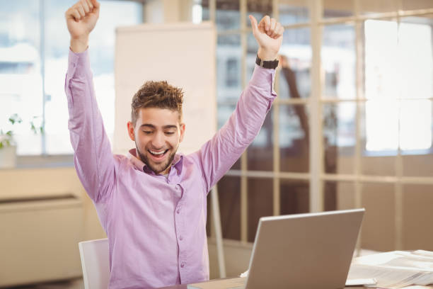 istock Happy businessman with arms raised 667205456