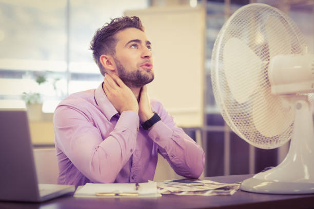 istock Businessman looking up while sitting at desk 667205744