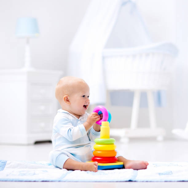 istock Baby playing with toy pyramid. Kids play 667205766