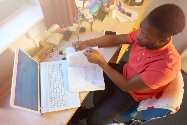 istock Male university student studying in his room at uni 667205808