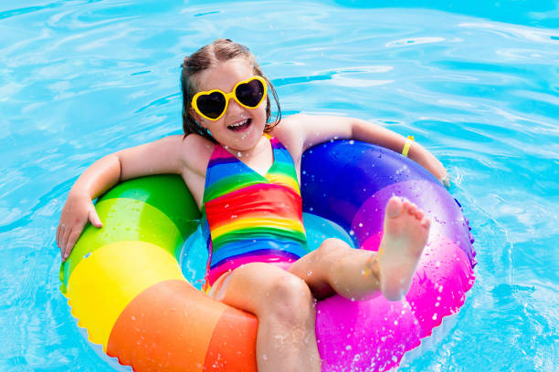istock Child with toy ring in swimming pool 667206174