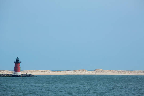 istock Red lighthouse and sand dunes near Cape Henlopen, Delaware. 667210688
