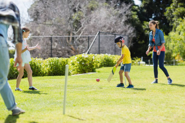 istock Happy family playing cricket together 667214272