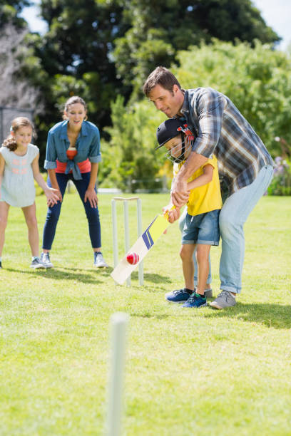 istock Happy family playing cricket together 667214422