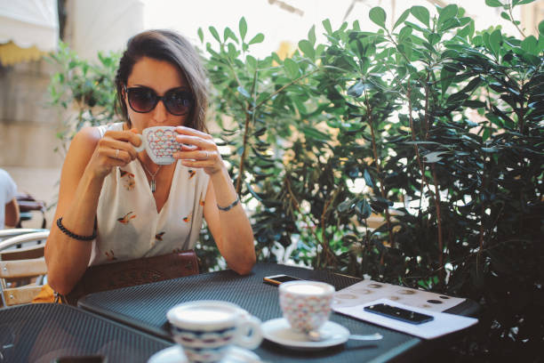 istock Young woman having a coffee in Trieste, Italy 667217432