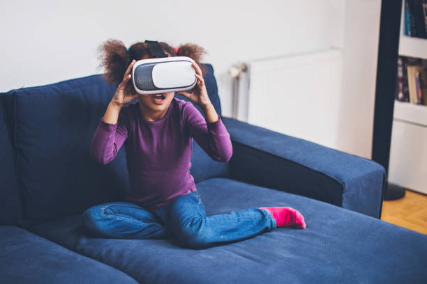 istock Cool millennial child exploring space with virtual reality glasses 667217456