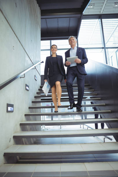 istock Business executives climbing down the stairs 667217784