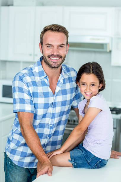 istock Happy father and daughter in kitchen at home 667218614